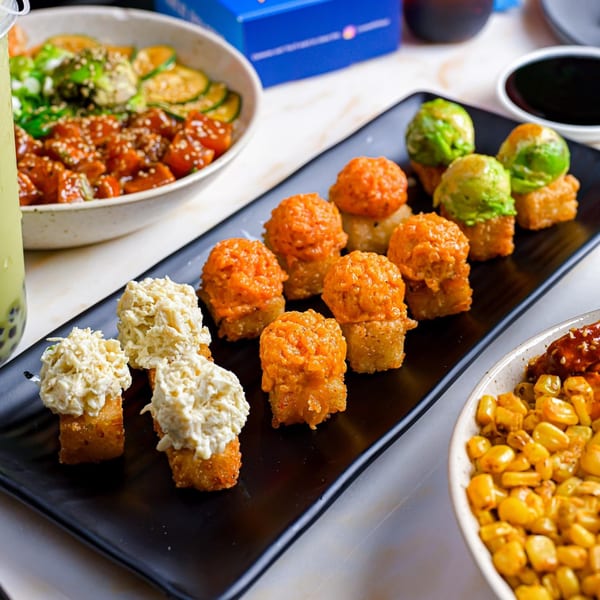 Sweetfish Poké Bowls & Sushi's crispy rice sushi with various toppings, a poké bowl, and corn.