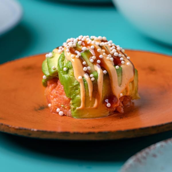 Sweetfish Poké Bowls & Sushi's salmon tartare with avocado, spicy mayo, and crispy rice pearls.